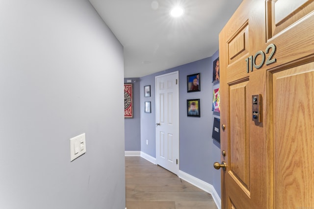 corridor with light wood-type flooring