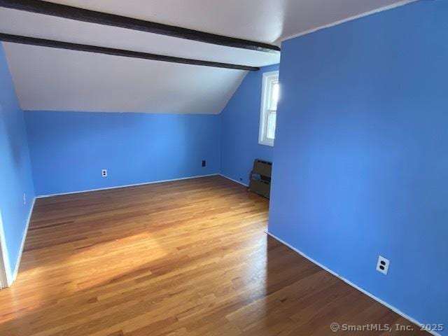 bonus room with vaulted ceiling with beams and hardwood / wood-style flooring