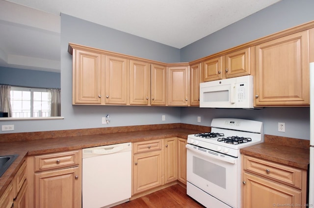 kitchen with light wood-type flooring, light brown cabinets, and white appliances