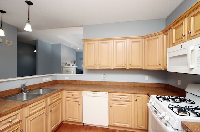 kitchen featuring pendant lighting, light brown cabinets, white appliances, sink, and light wood-type flooring