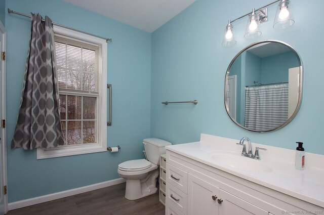 bathroom with vanity, hardwood / wood-style flooring, and toilet