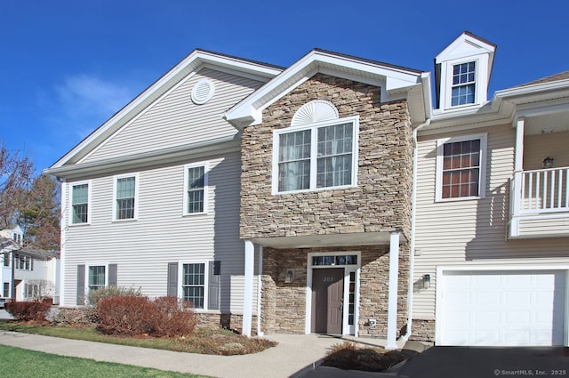 view of front of house with stone siding and an attached garage