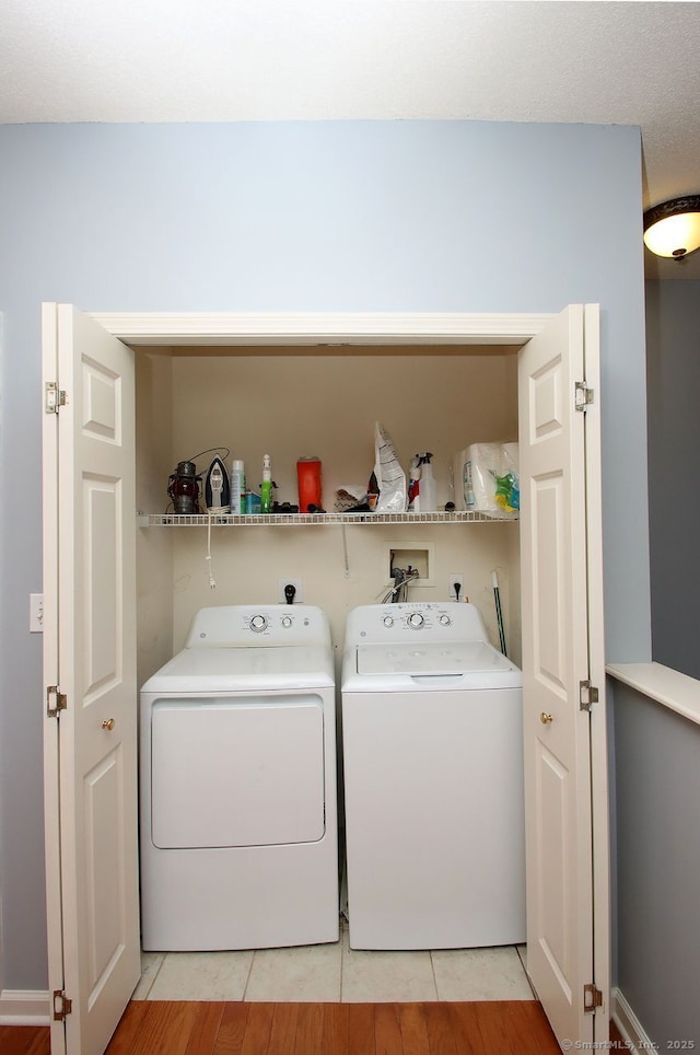 laundry area featuring washing machine and dryer and tile patterned floors