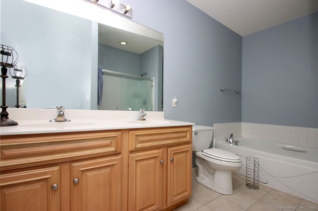 full bathroom featuring tile patterned flooring, vanity, toilet, and separate shower and tub