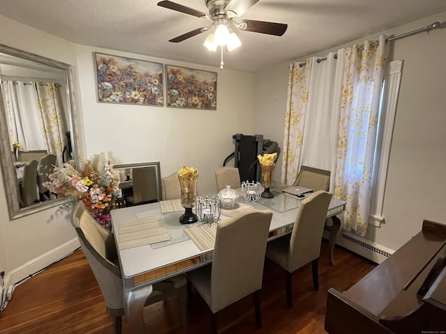 dining space featuring a textured ceiling, ceiling fan, dark wood-type flooring, and a baseboard radiator