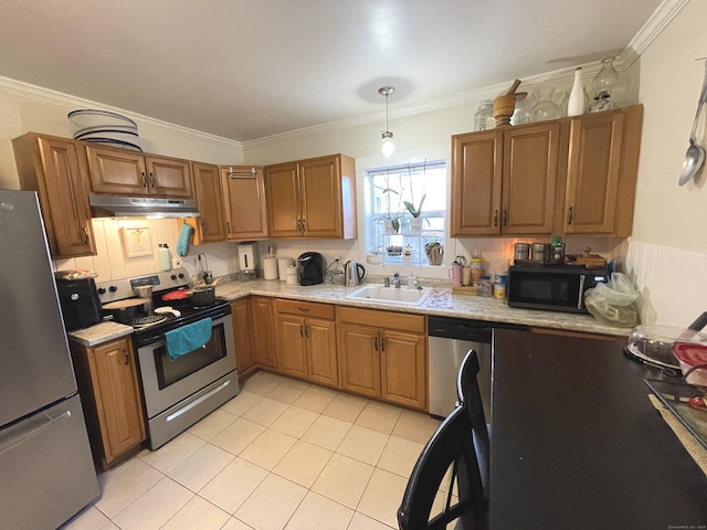 kitchen featuring appliances with stainless steel finishes, ornamental molding, sink, light tile patterned floors, and hanging light fixtures