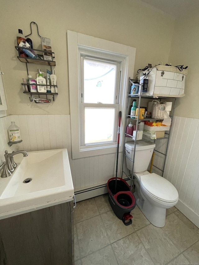 bathroom featuring tile patterned floors, vanity, a baseboard radiator, and toilet