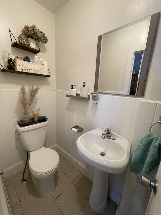 bathroom with tile patterned flooring and toilet