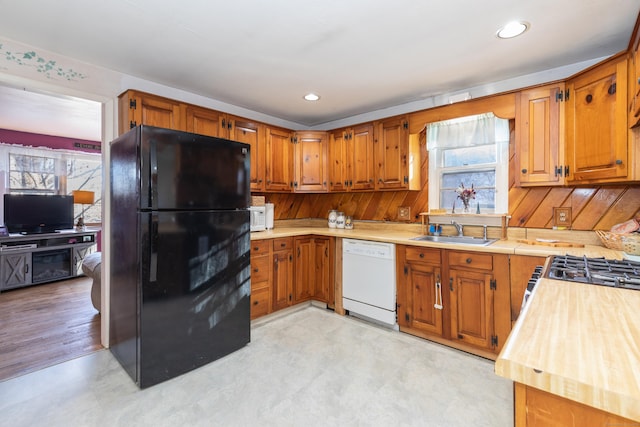 kitchen featuring white appliances, sink, and wooden counters