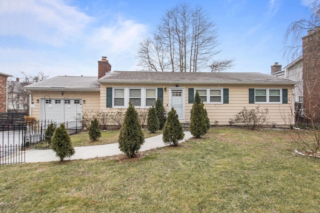 ranch-style house with a garage and a front lawn