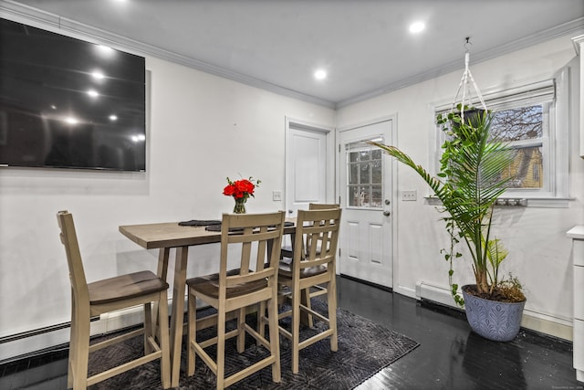 dining room featuring baseboard heating, crown molding, and dark wood-type flooring