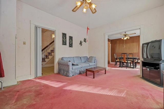 living room with ceiling fan and carpet