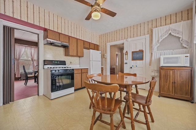 kitchen featuring ceiling fan, white appliances, and radiator