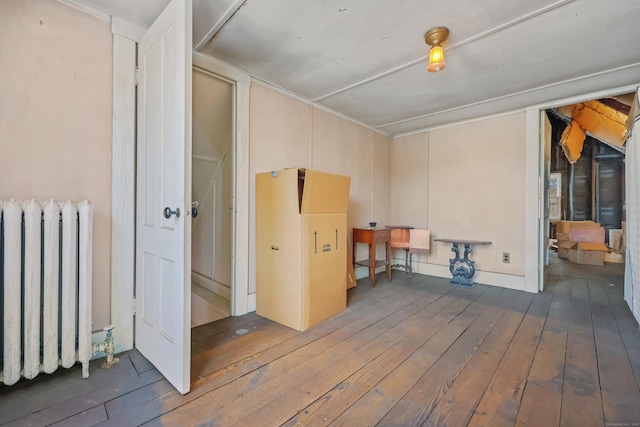 interior space featuring radiator heating unit and dark wood-type flooring