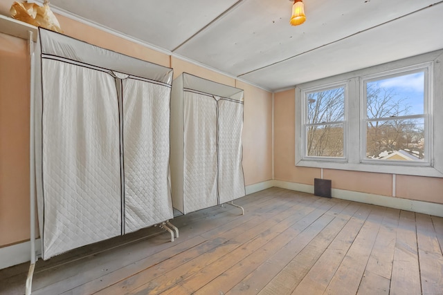 interior space featuring hardwood / wood-style flooring and crown molding