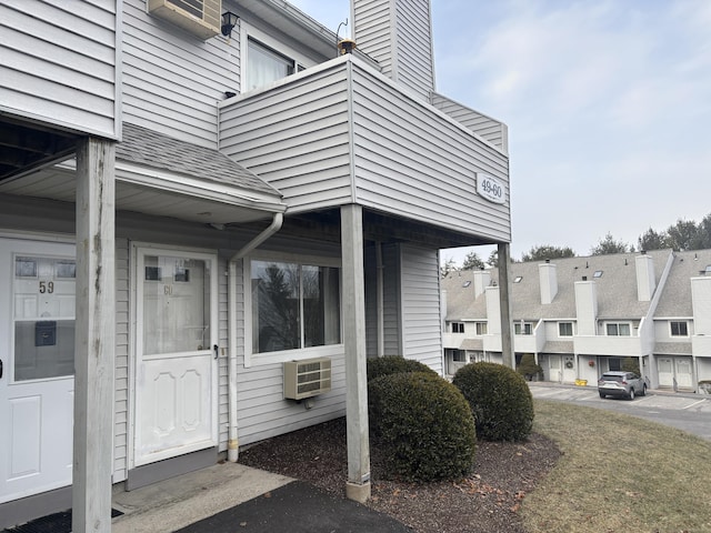 entrance to property featuring a wall unit AC