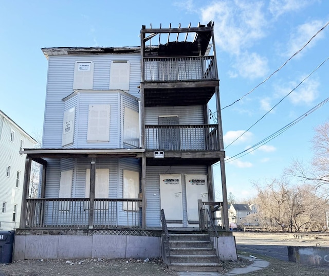 view of front of house with a balcony and covered porch