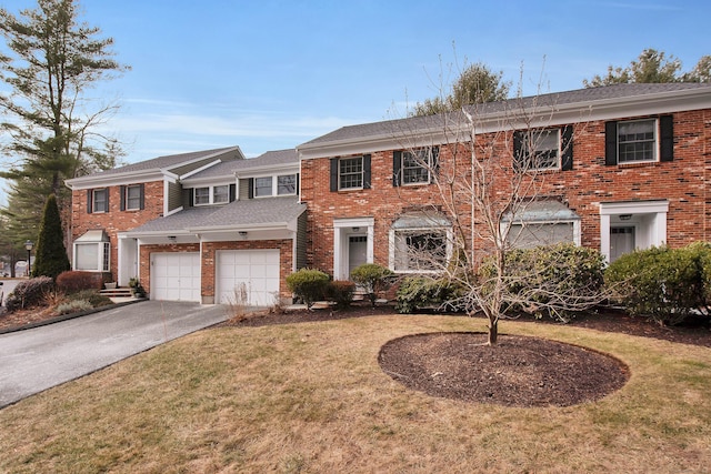 multi unit property with a garage and a front lawn