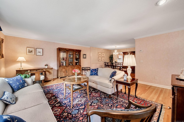 living area with ornamental molding, baseboards, and wood finished floors