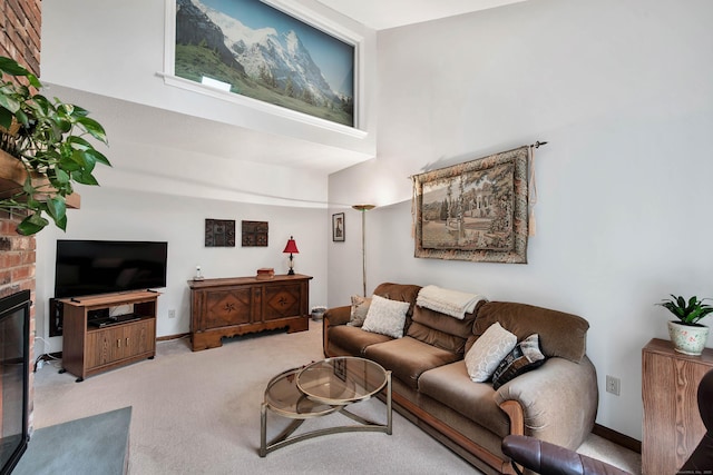 living room with a high ceiling, baseboards, and carpet floors