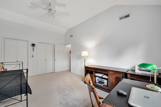 office space featuring a ceiling fan, baseboards, visible vents, vaulted ceiling, and light carpet