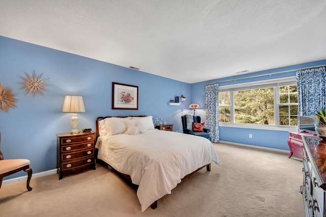 bedroom with light carpet, visible vents, a textured ceiling, and baseboards