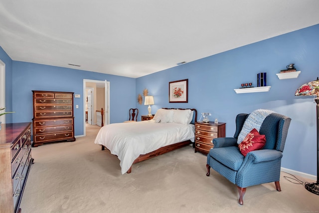 carpeted bedroom featuring visible vents and baseboards