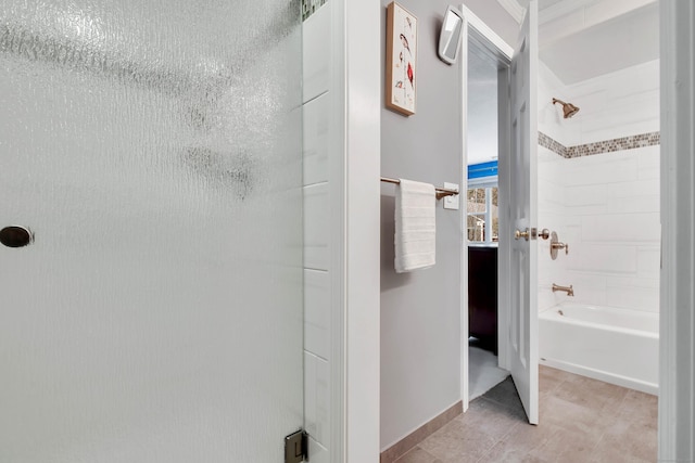 corridor with light tile patterned floors and baseboards