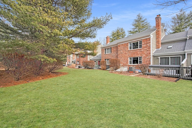 view of yard with a deck and central AC