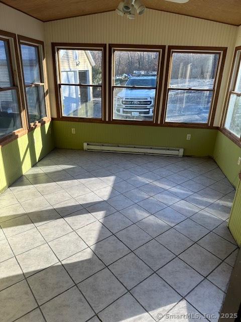 unfurnished sunroom featuring ceiling fan, wooden ceiling, and a baseboard heating unit