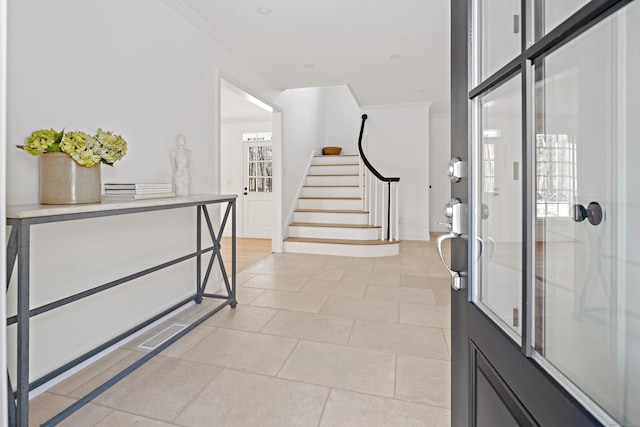 entrance foyer featuring a wealth of natural light and crown molding