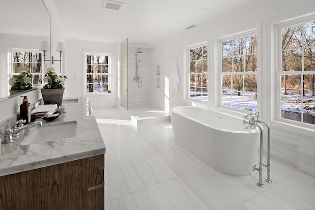 bathroom with tile patterned flooring, vanity, and shower with separate bathtub