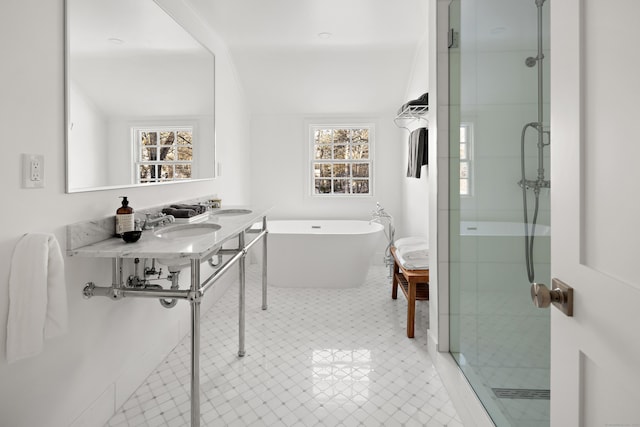 bathroom featuring double sink, plus walk in shower, a healthy amount of sunlight, and lofted ceiling