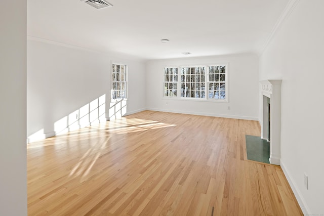 unfurnished living room with light wood-type flooring and crown molding