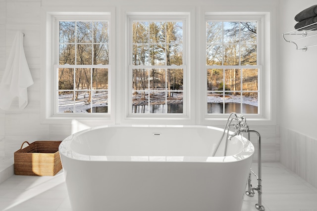 bathroom featuring tile patterned floors and a bathing tub