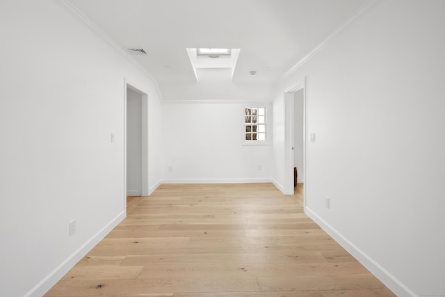 hall featuring a skylight, light hardwood / wood-style flooring, and crown molding