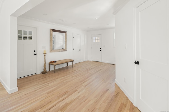 entrance foyer featuring light hardwood / wood-style flooring and ornamental molding