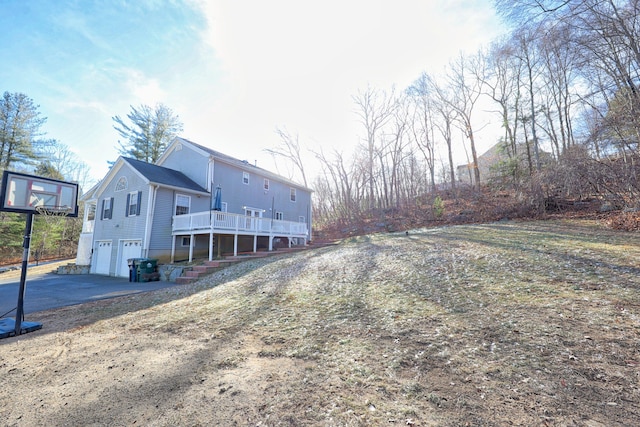 exterior space featuring a wooden deck and a garage