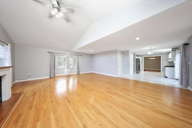 unfurnished living room with ceiling fan, light wood-type flooring, and lofted ceiling