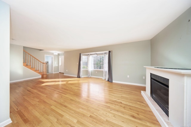 unfurnished living room featuring light wood-type flooring