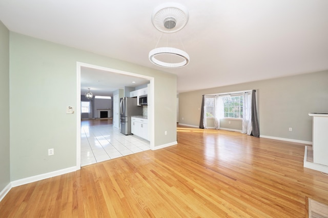 unfurnished living room featuring light wood-type flooring