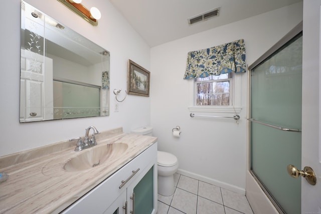 full bathroom featuring shower / bath combination with glass door, tile patterned floors, vanity, and toilet