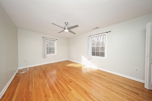 spare room featuring wood-type flooring and ceiling fan