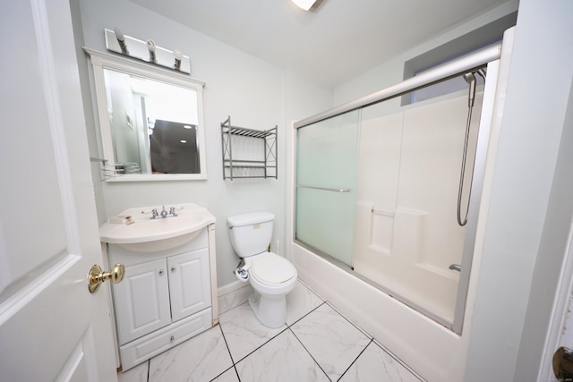 full bathroom featuring vanity, toilet, and bath / shower combo with glass door