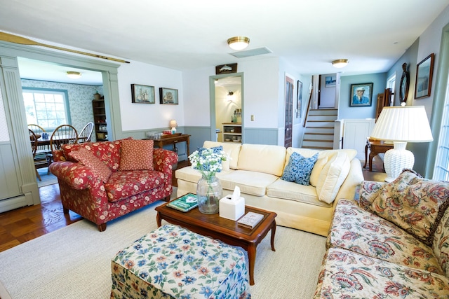 living room featuring light parquet flooring and a baseboard heating unit