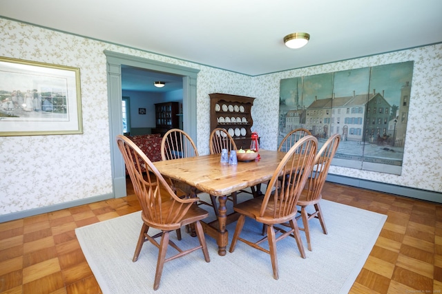 dining room with a baseboard radiator and parquet flooring