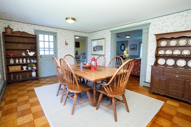 dining room featuring a baseboard radiator and light parquet floors