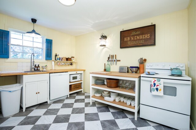 kitchen featuring wooden counters, white appliances, sink, decorative light fixtures, and white cabinets