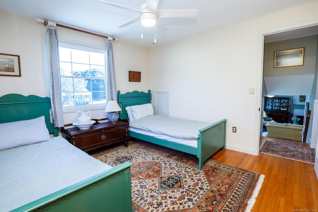 bedroom featuring ceiling fan and wood-type flooring