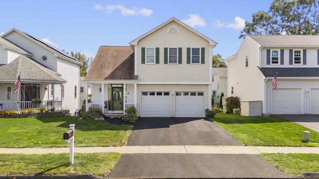 view of property with a garage and a front yard